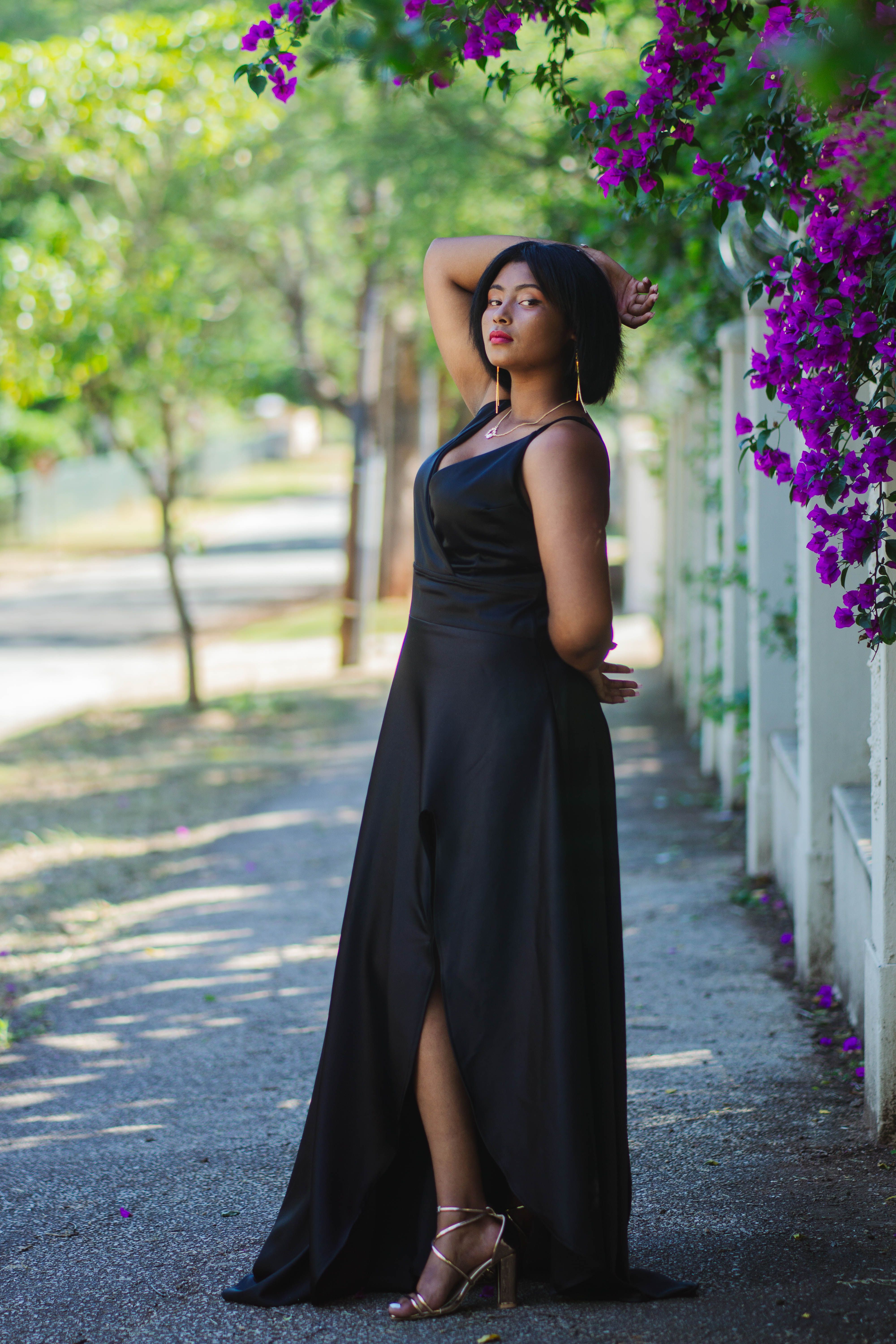 Young Woman in a Black Dress Standing on the Sidewalk · Free Stock Photo