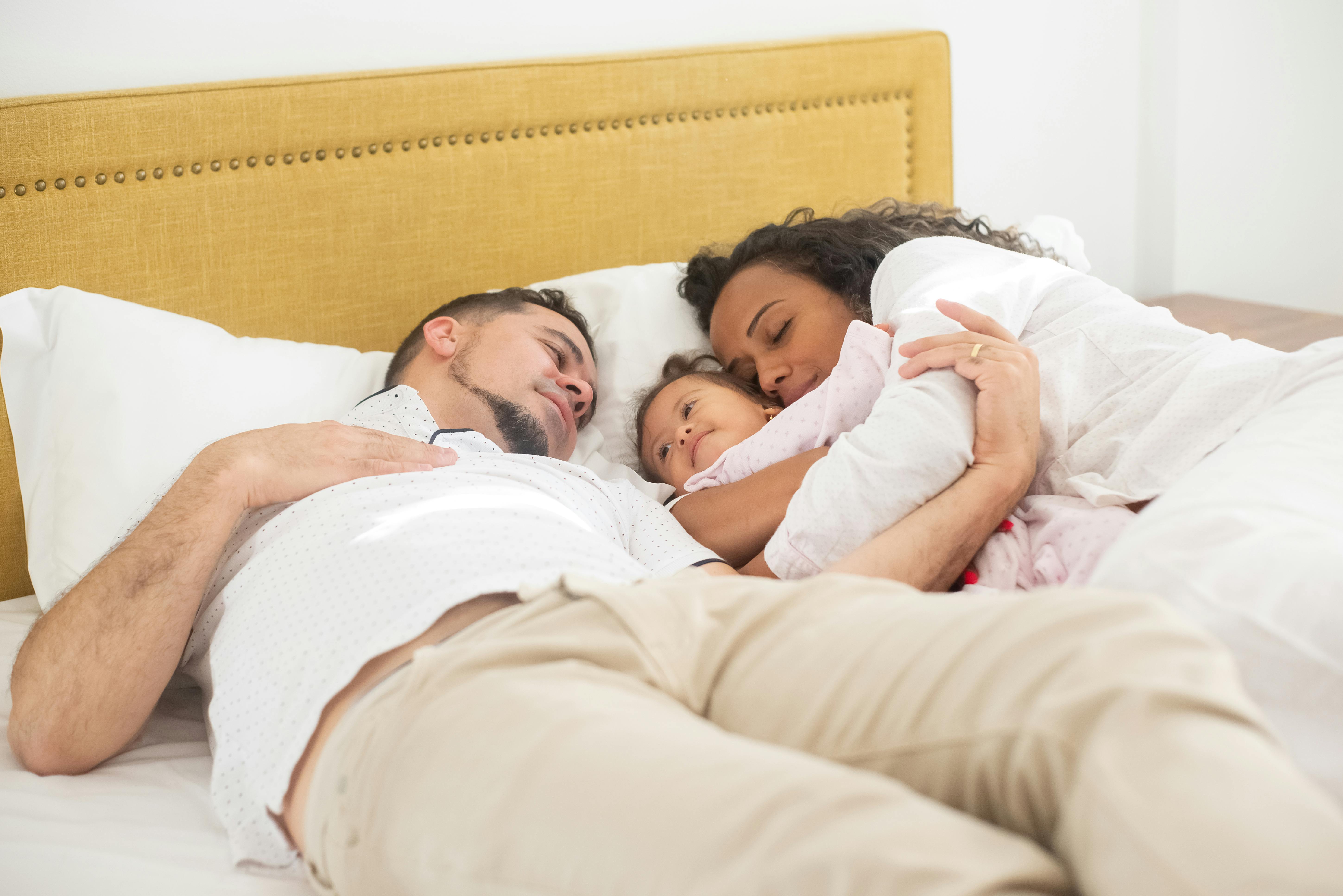 family lying on the bed