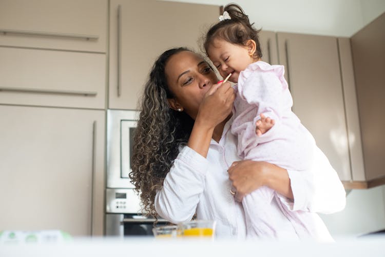 Woman Feeding Her Child