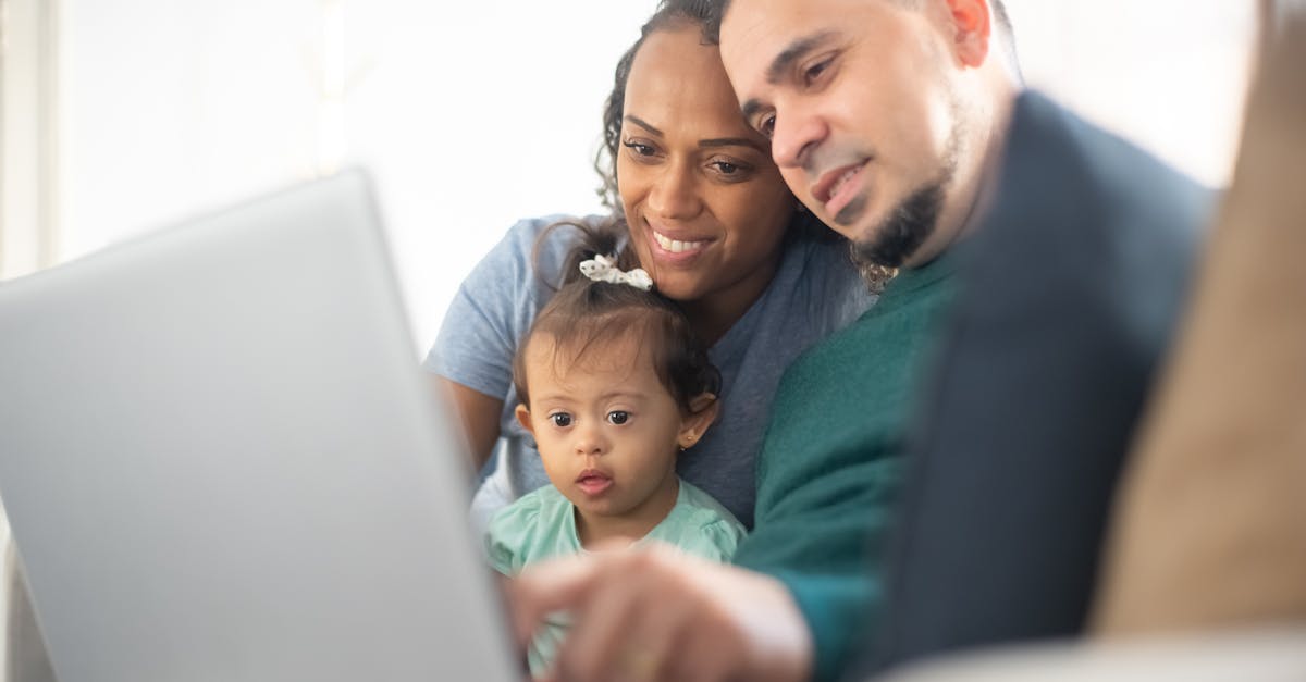 Family engaging with smart technology on a laptop, highlighting the convenience and integration of smart appliances in home life.