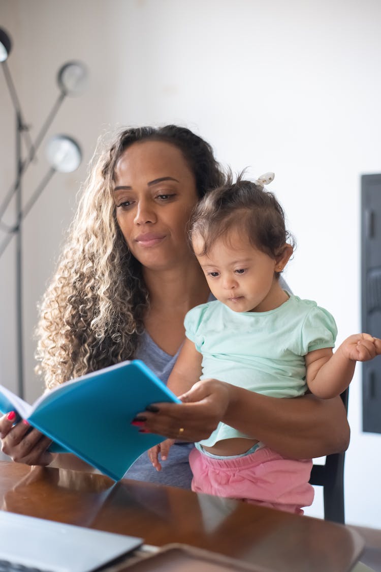 Mother Reading A Story To Her Daughter