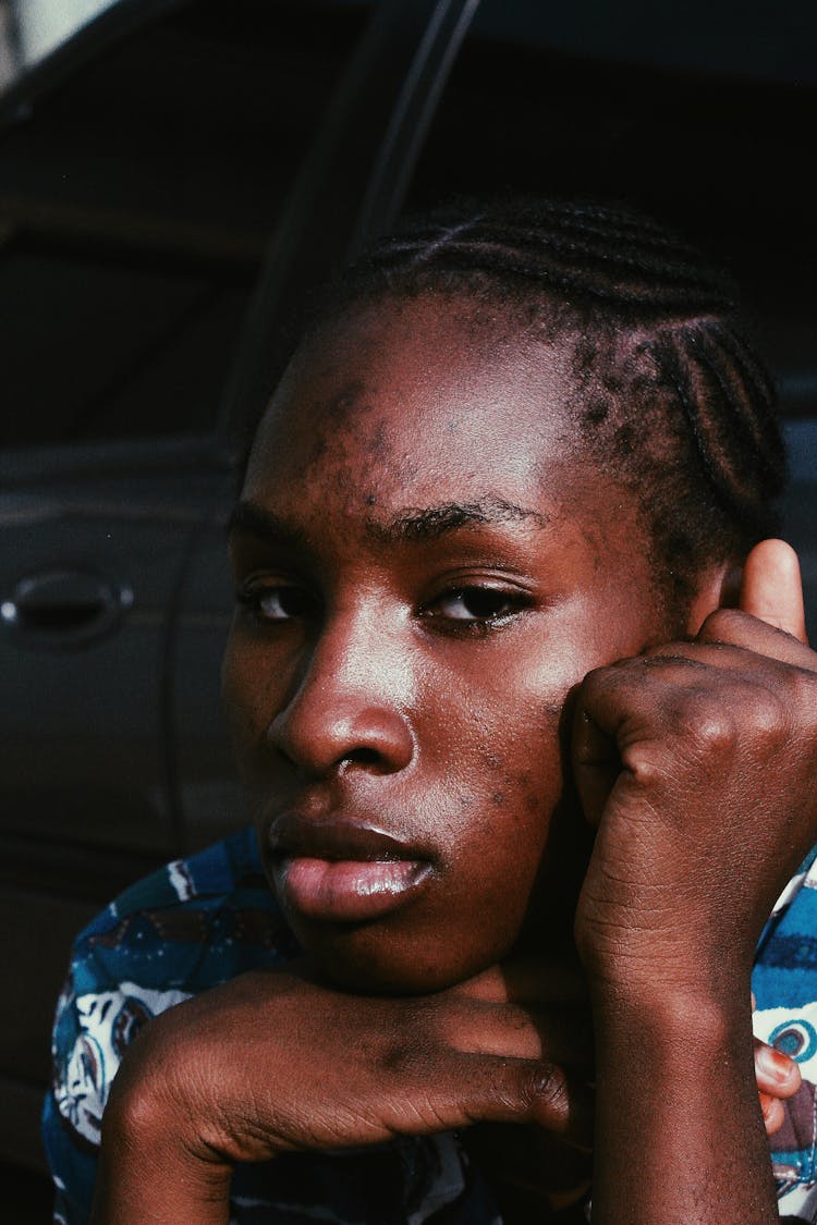 Serious Black Woman Sitting Near Car