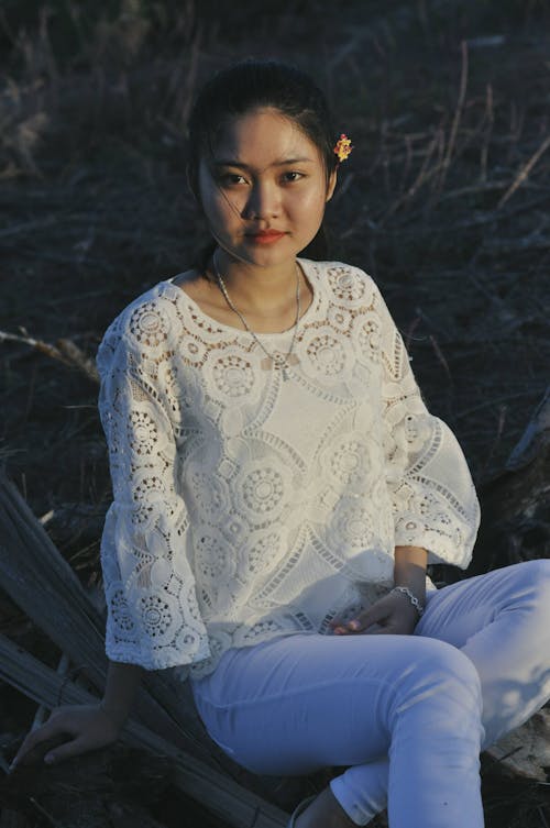 A Woman Wearing a White Lacey Top