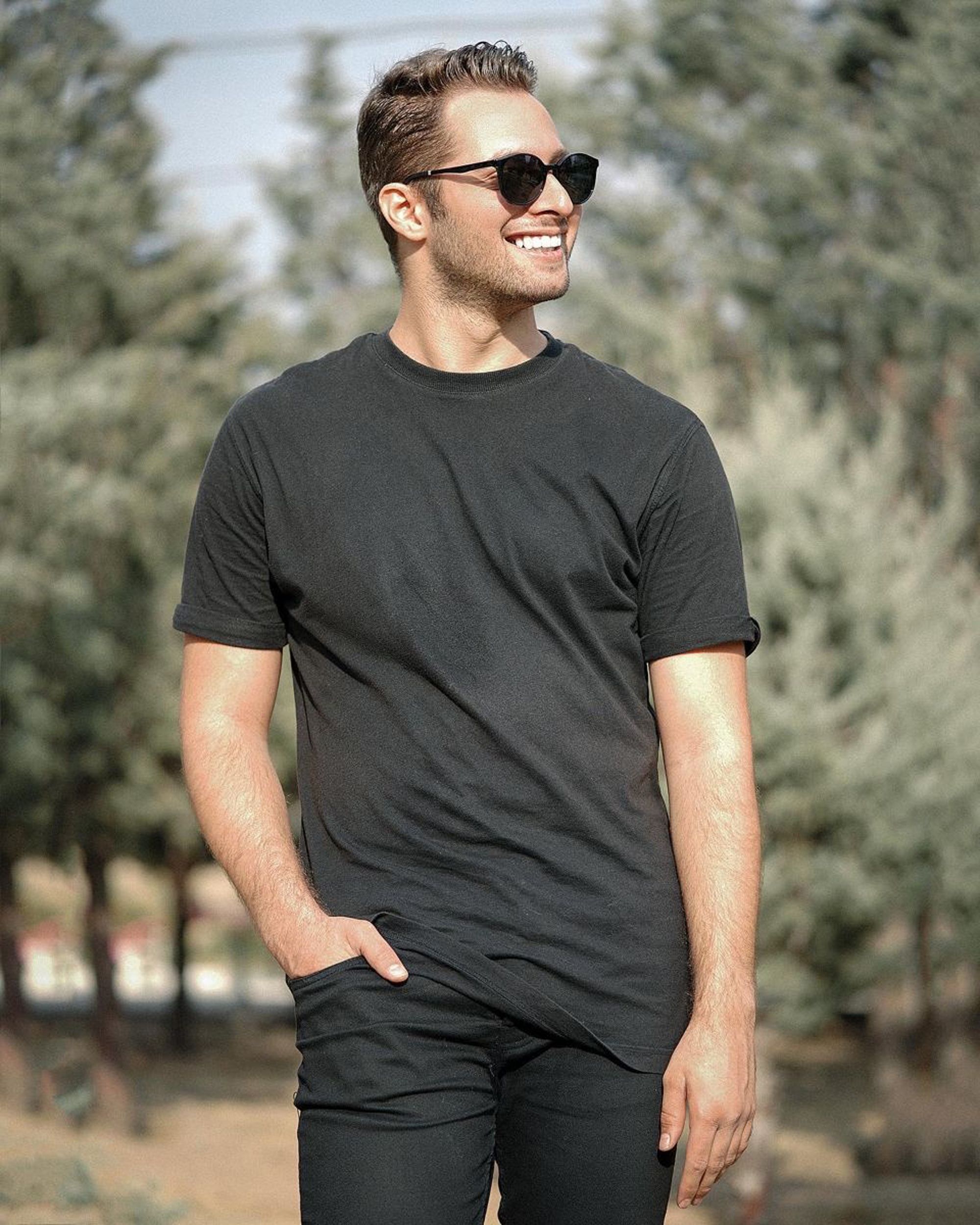 A Man in a Black Shirt Wearing Sunglasses · Free Stock Photo