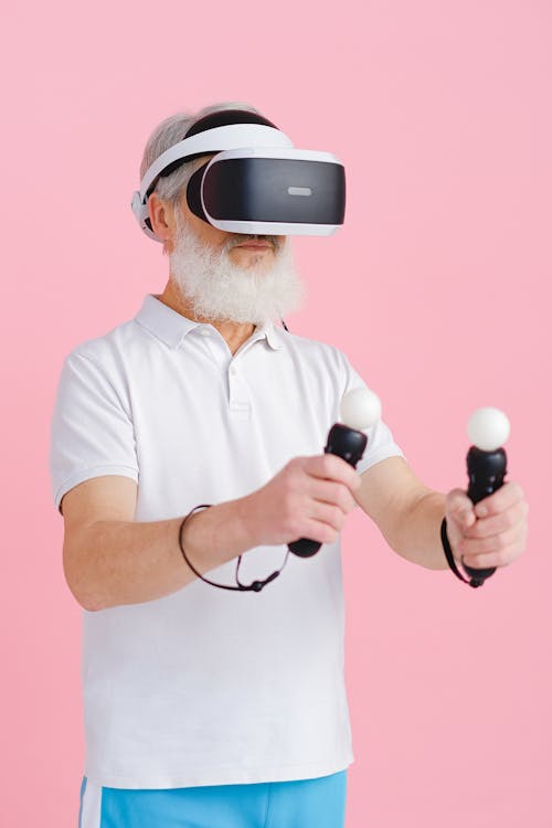 Free An Elderly Man Playing Virtual Reality Game Stock Photo
