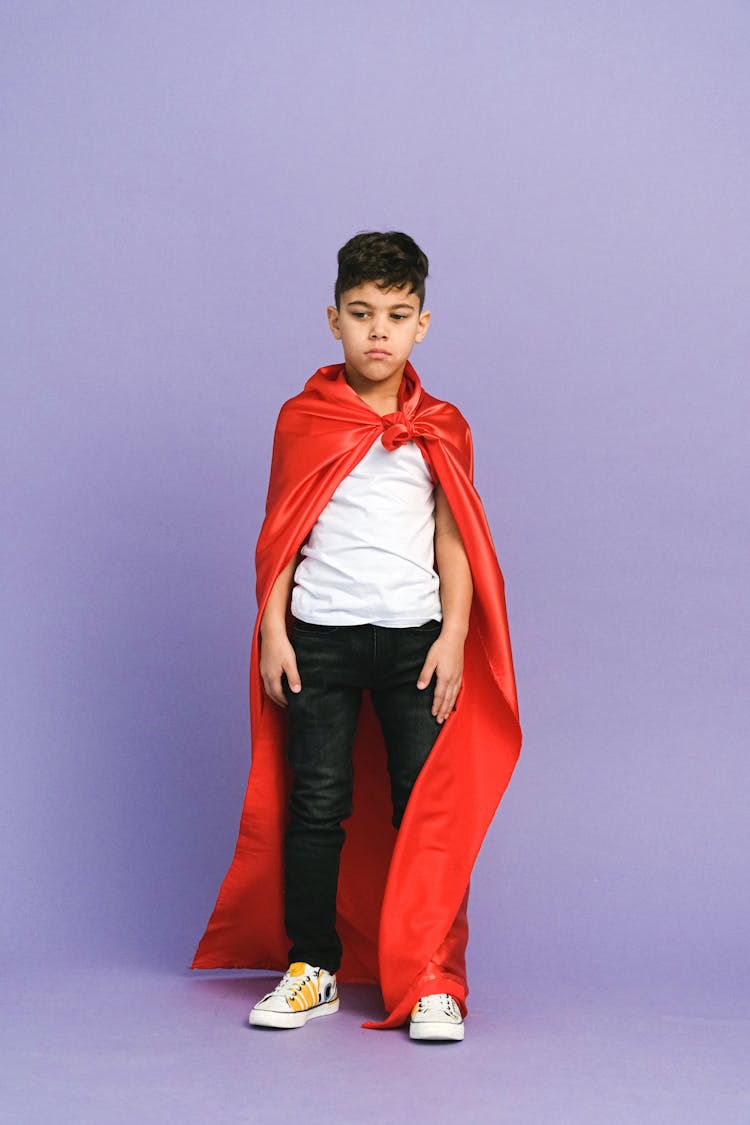 A Boy Wearing A Red Cape