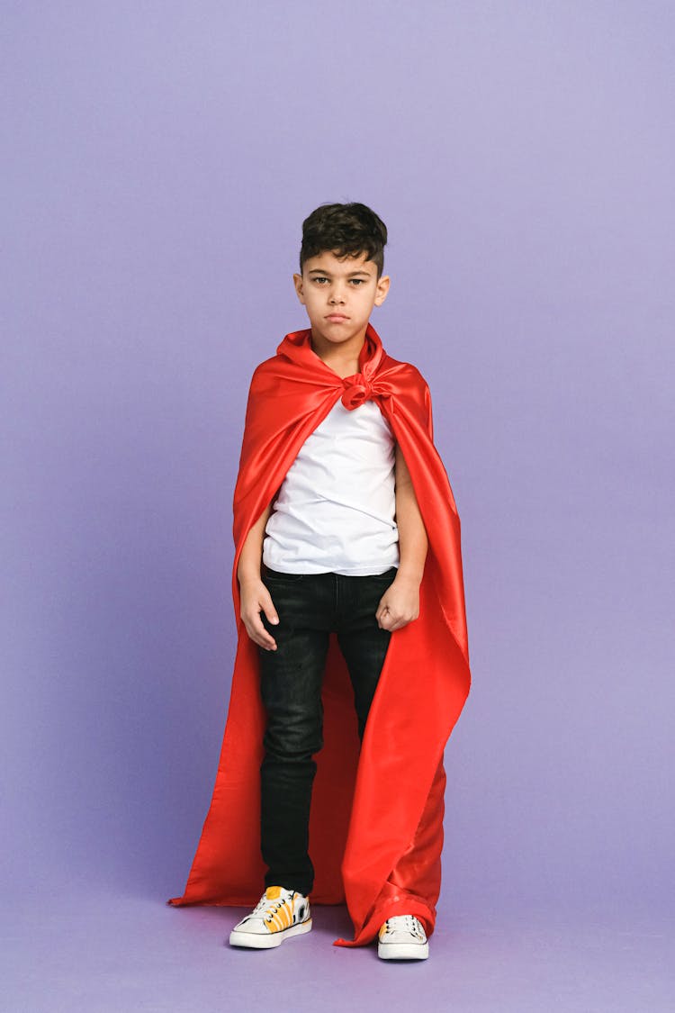 A Boy Wearing A Red Cape