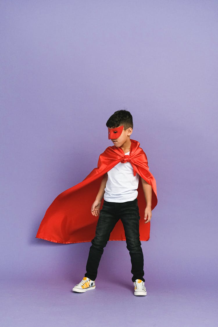 A Boy Wearing A Superhero Costume