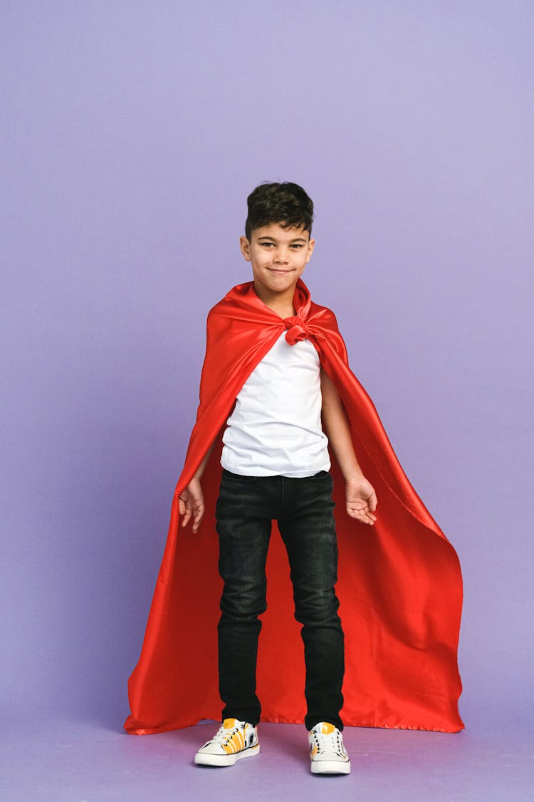 A Boy Wearing A Superhero Costume