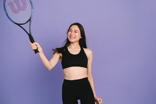 Woman Wearing Sports Bra Holding a Racket