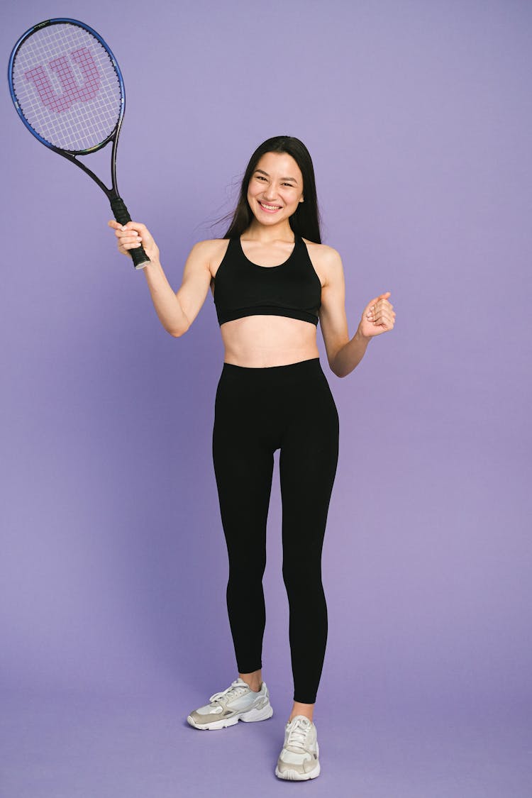 Happy Woman Holding A Tennis Racket