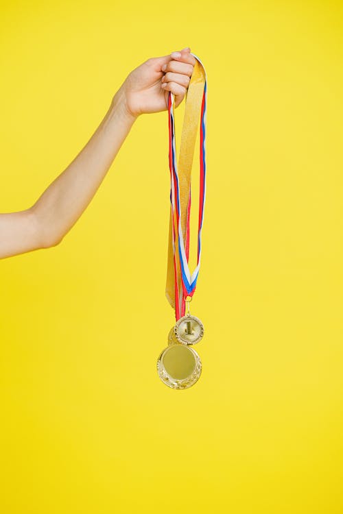 Person Holding Medals