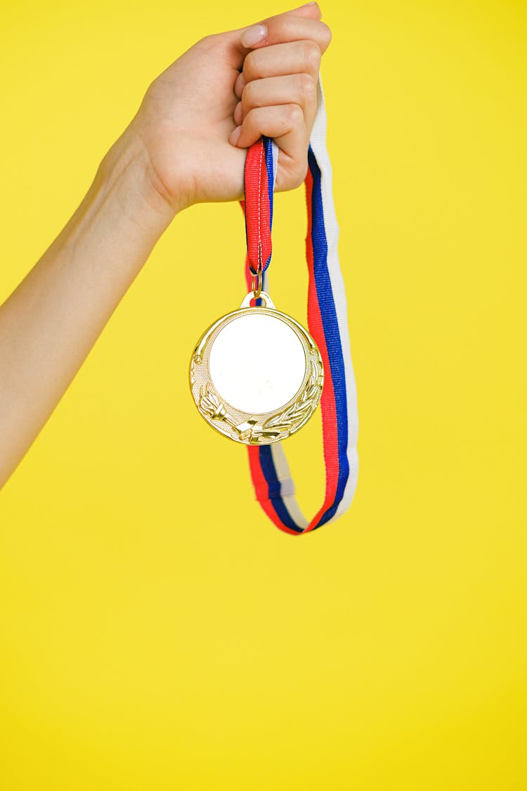 A Person Holding A Medal