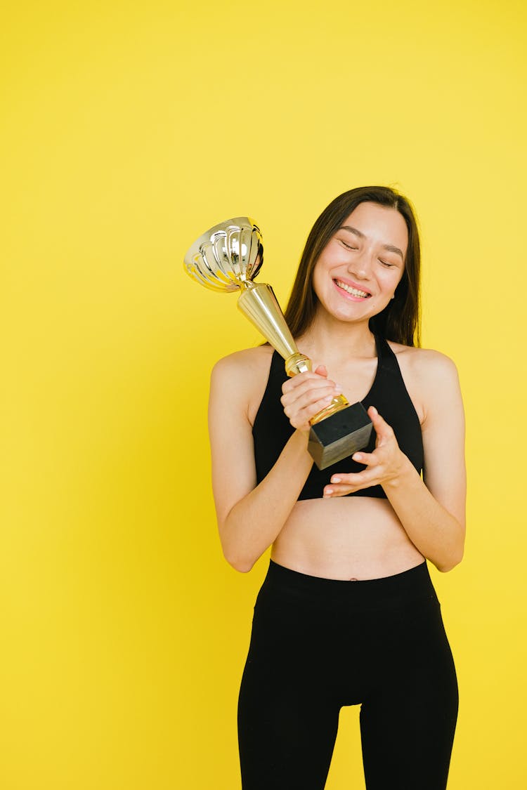 A Woman Holding A Trophy