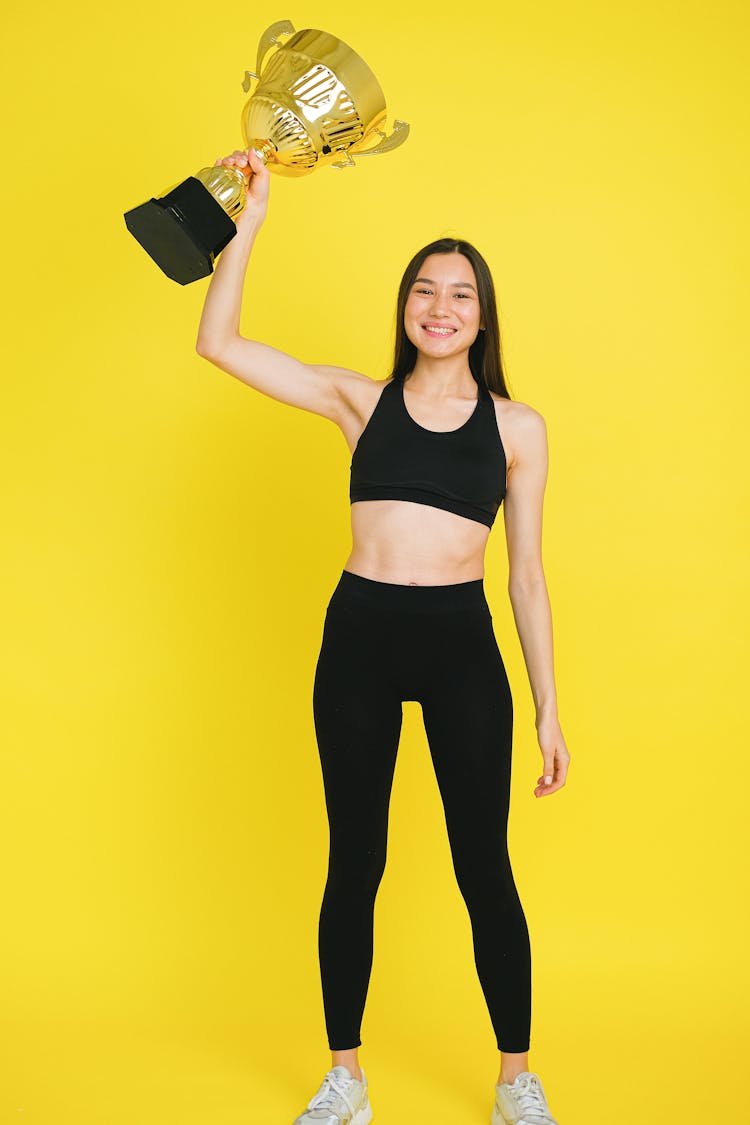 Happy Woman Holding A Trophy