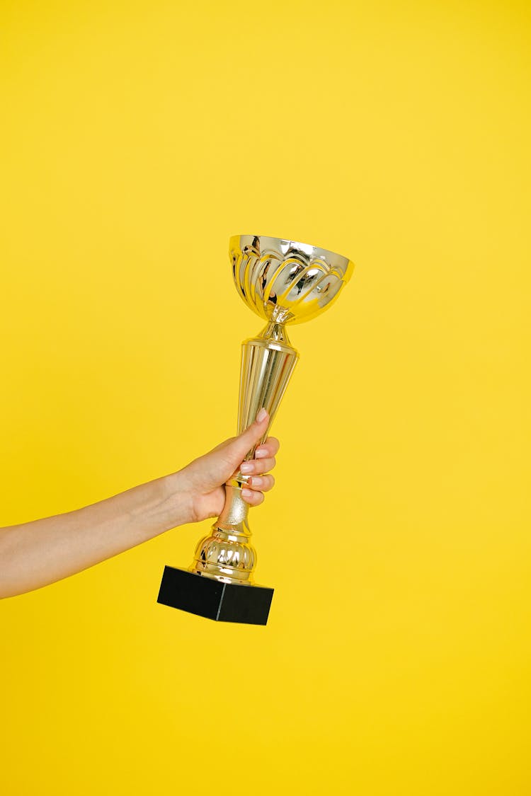 Close Up Photo Of  Person Holding A Trophy