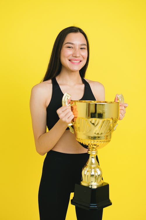 Woman Holding a Gold Trophy
