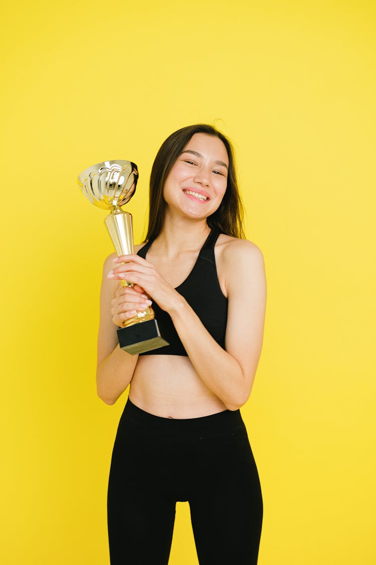 Happy Woman Holding A Trophy