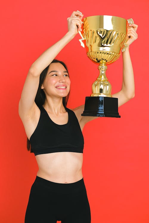 Free A Woman Holding a Trophy  Stock Photo