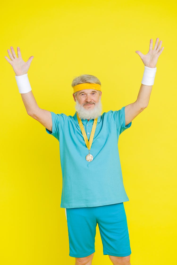 An Elderly Man Winning A Gold Medal