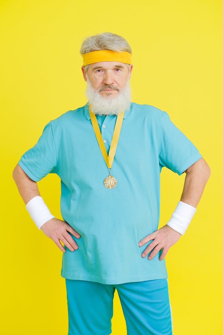 An Elderly Man Winning A Gold Medal