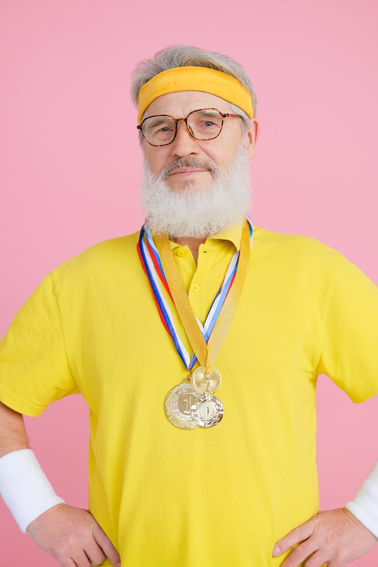 An Elderly Man Wearing Gold Medals