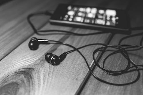 Free Black earphones on a desk Stock Photo