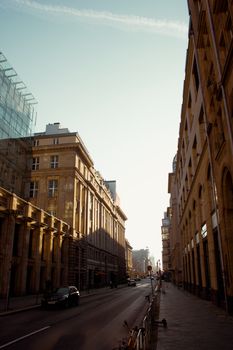 Morning sun illuminates a Berlin street, capturing urban charm and architecture.