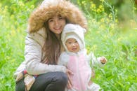 A Woman and a Child Smiling and Posing at the Camera