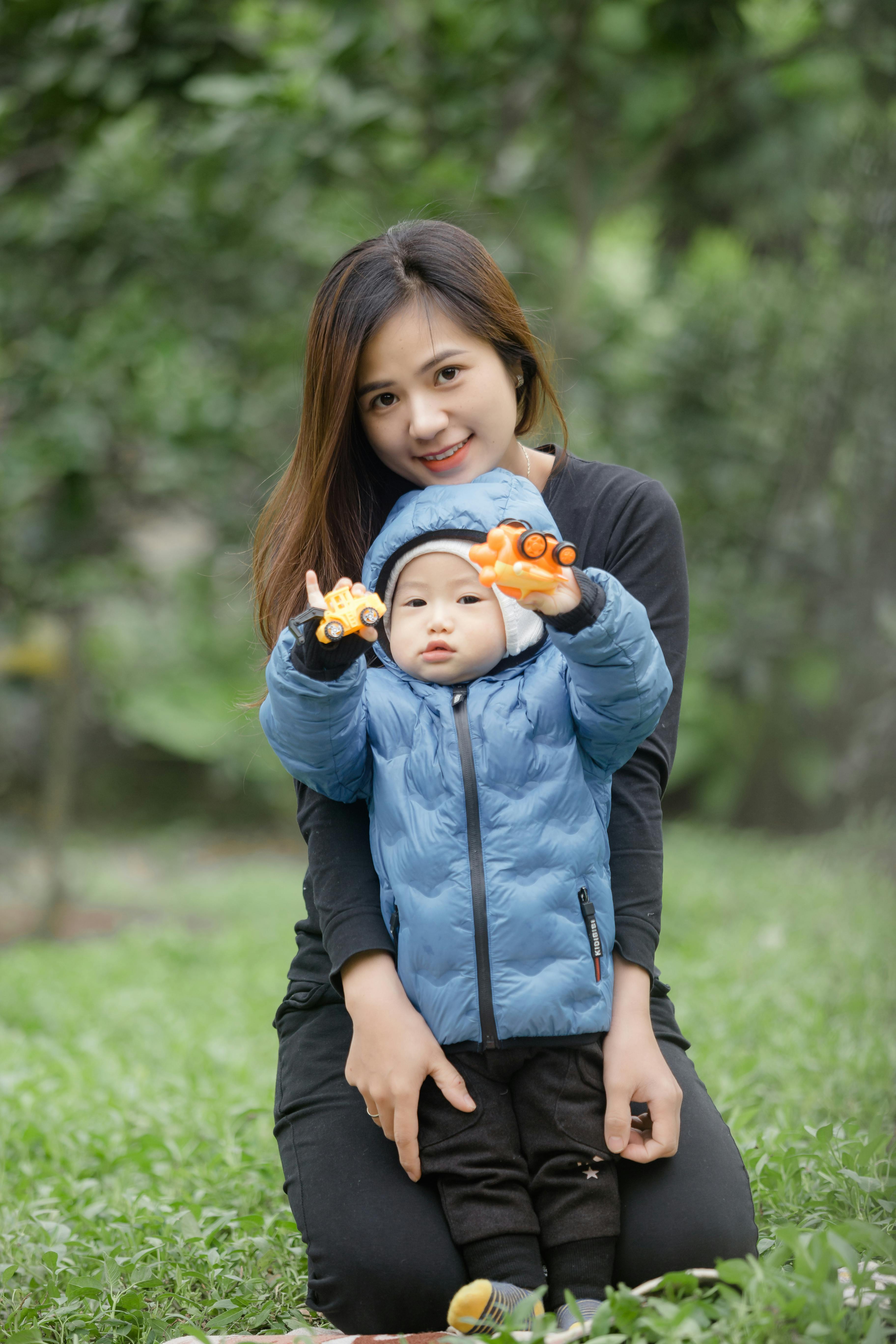 a woman and a child looking at the camera