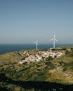 White Wind Turbine on Green Grass Field