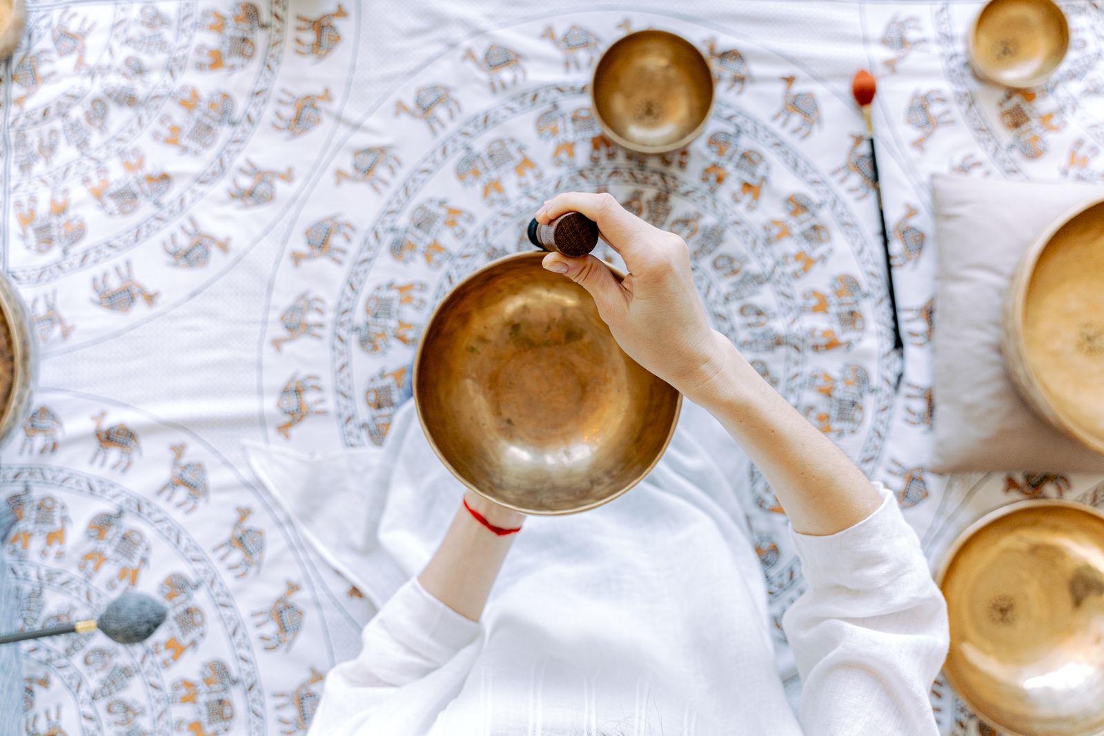 Top-down view of brass bowls being played