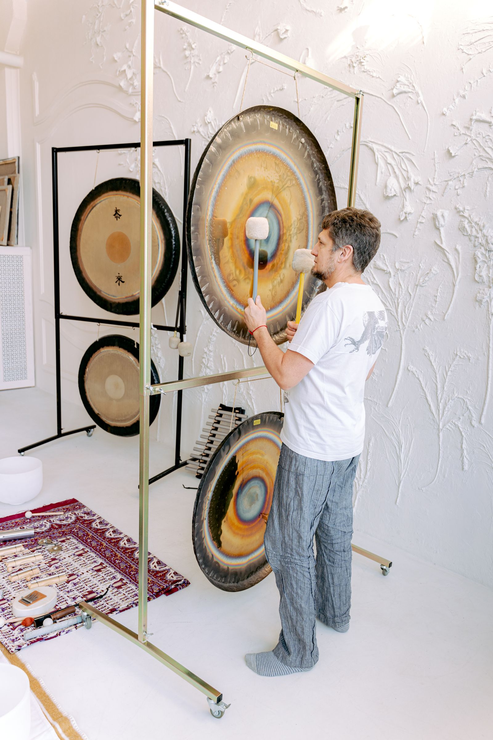 Practitioner playing a large gong
