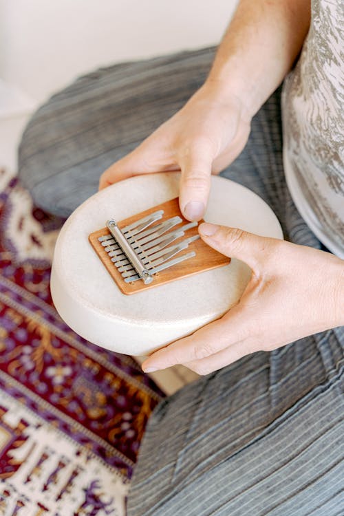 Free Photo of a Person's Hands Using a Kalimba Stock Photo