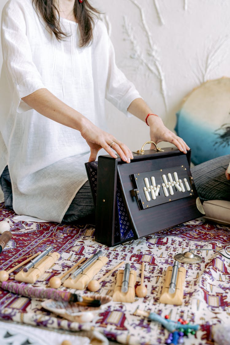 Woman Unpacking Case With Art Supplies