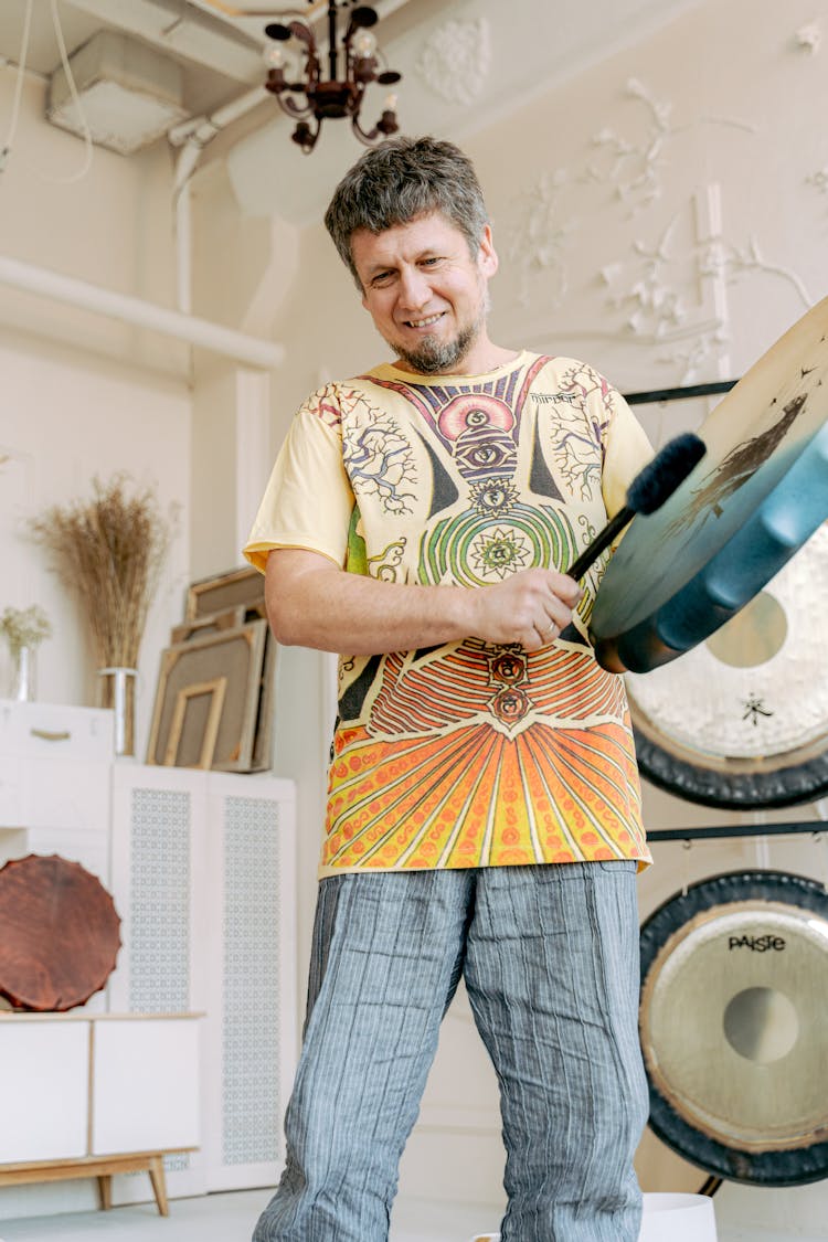 Man Holding A Mallet And Gong