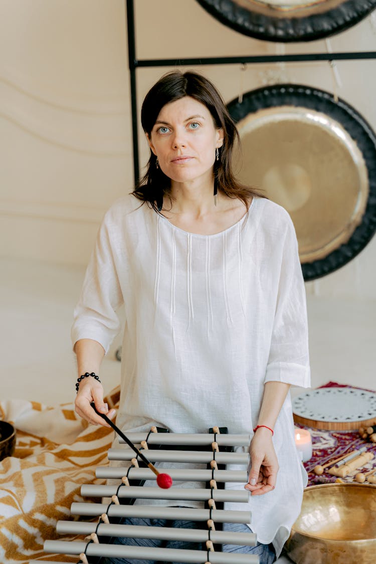 Woman In White Top Playing A Xylophone