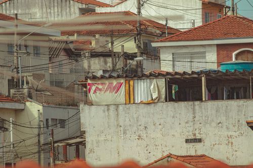 Free Exterior of aged weathered residential buildings with wires hanging on pillars in poor village Stock Photo
