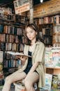 Calm Asian woman reading book in bookshop