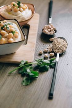 Close-up of a delicious hummus dish topped with chickpeas and sesame seeds.