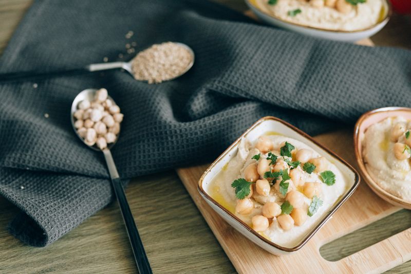 baked sweet potato topped with hummus and chickpeas