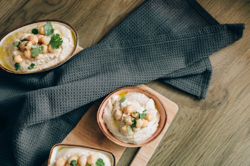 Close-Up Shot of Hummus on Bowls