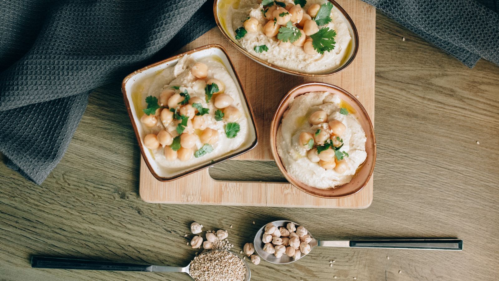 Hummus garnished with chickpeas and herbs in a bowl — photo by Nataliya Vaitkevich on Pexels Hummus garnished with chickpeas and herbs in a bowl