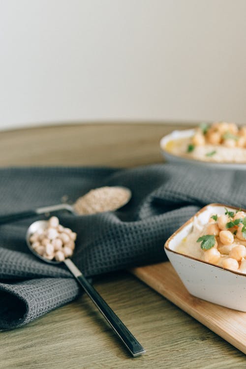 Close-Up Shot of Hummus on Bowls