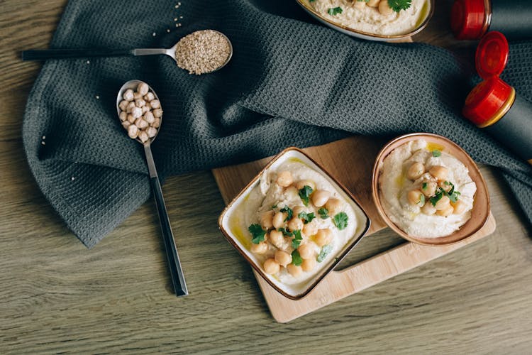 Overhead Shot Of Hummus Near Spoons