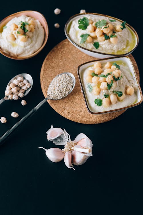 Free Close-Up Shot of Hummus on Bowls Stock Photo