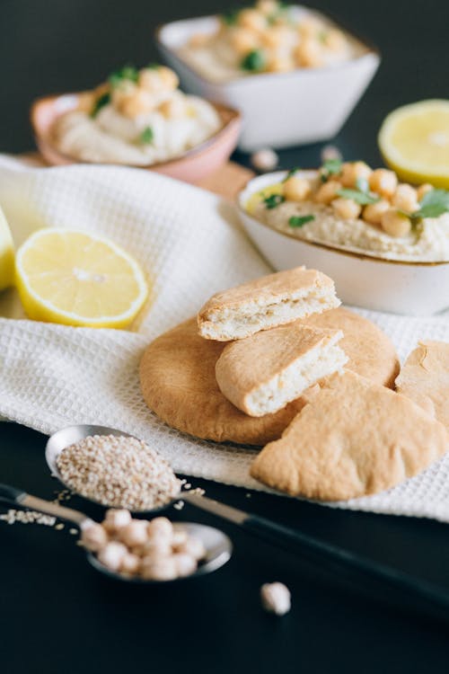 A Bread Near Bowls of Hummus