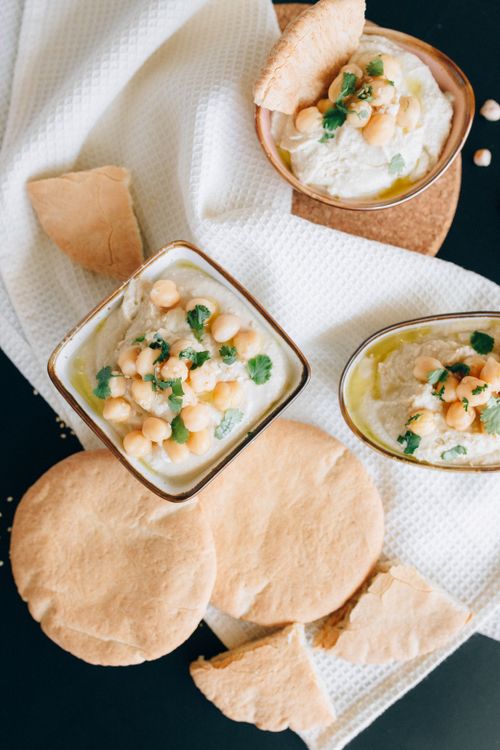 Free Creamy hummus topped with chickpeas and herbs, served with flatbread. Stock Photo