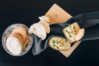 Photo of Hummus and Bread on Top of a Chopping Board