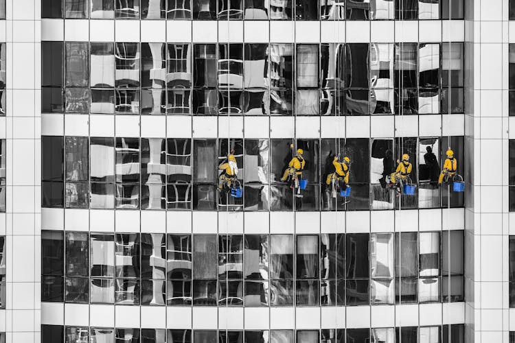 Five Person Cleaning Glass Building